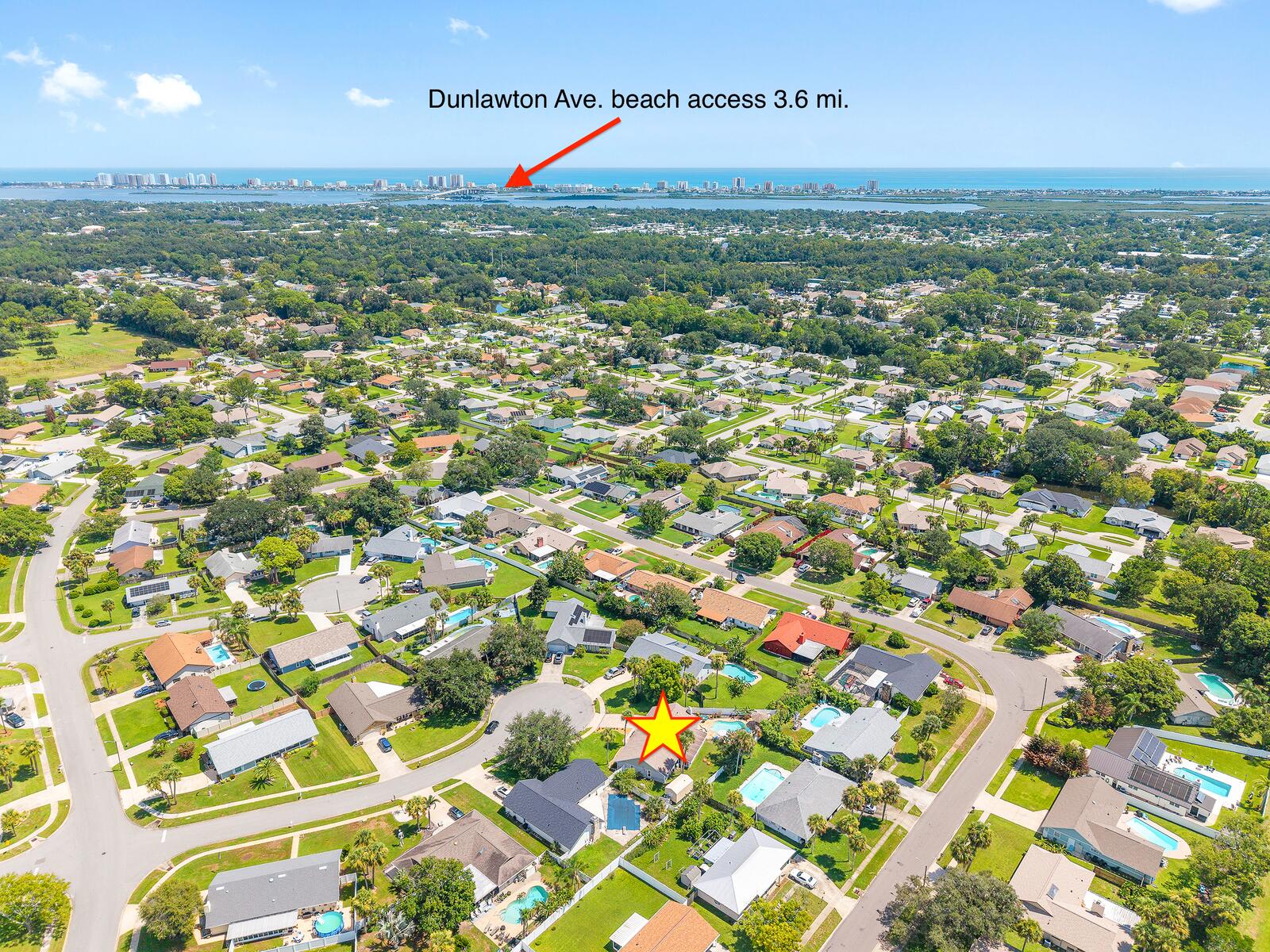 Aerial view from The Checkered Palm toward the ocean, with the Dunlawton Avenue beach access about 3.6 miles away
