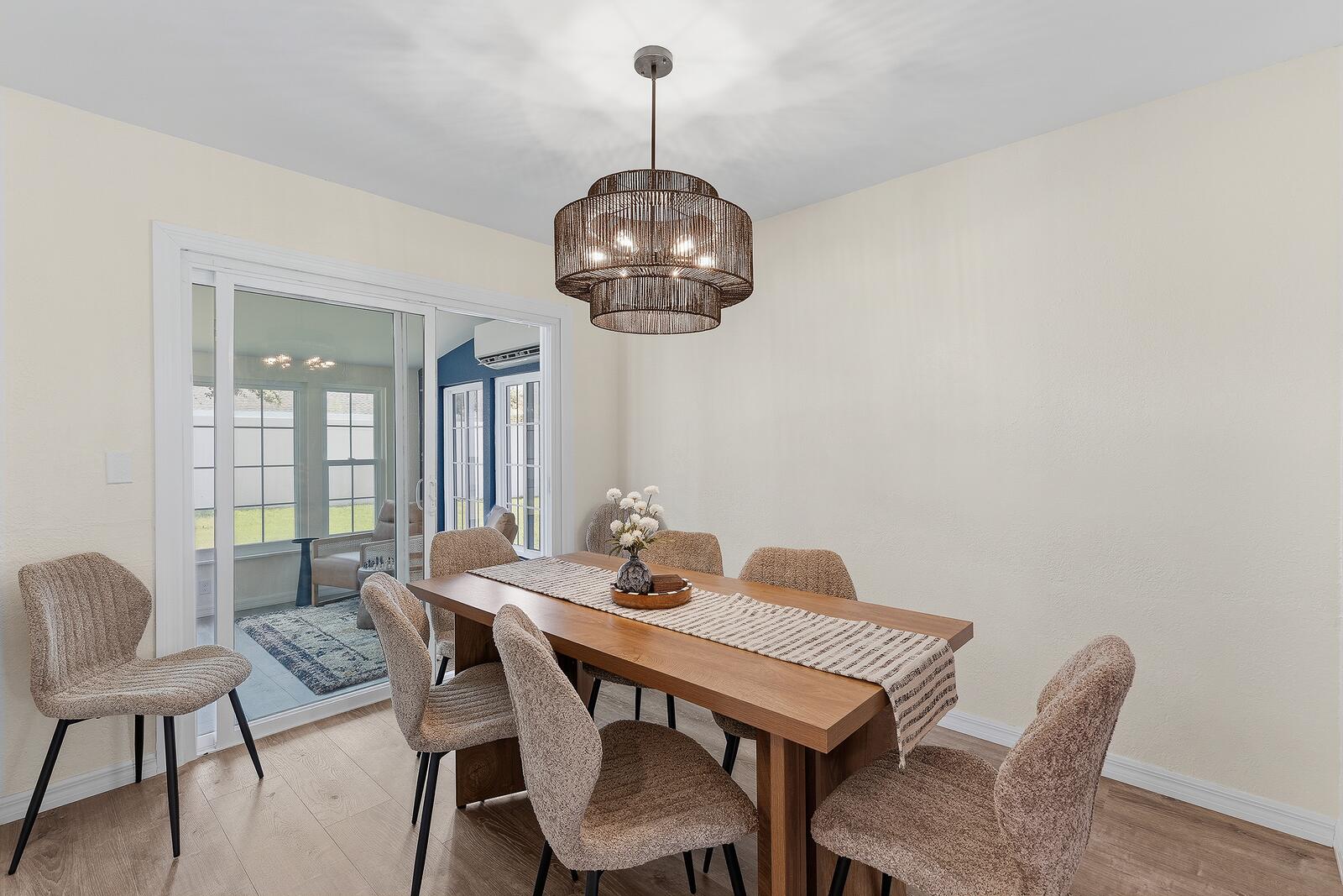 Dining room seating six next to the sunroom