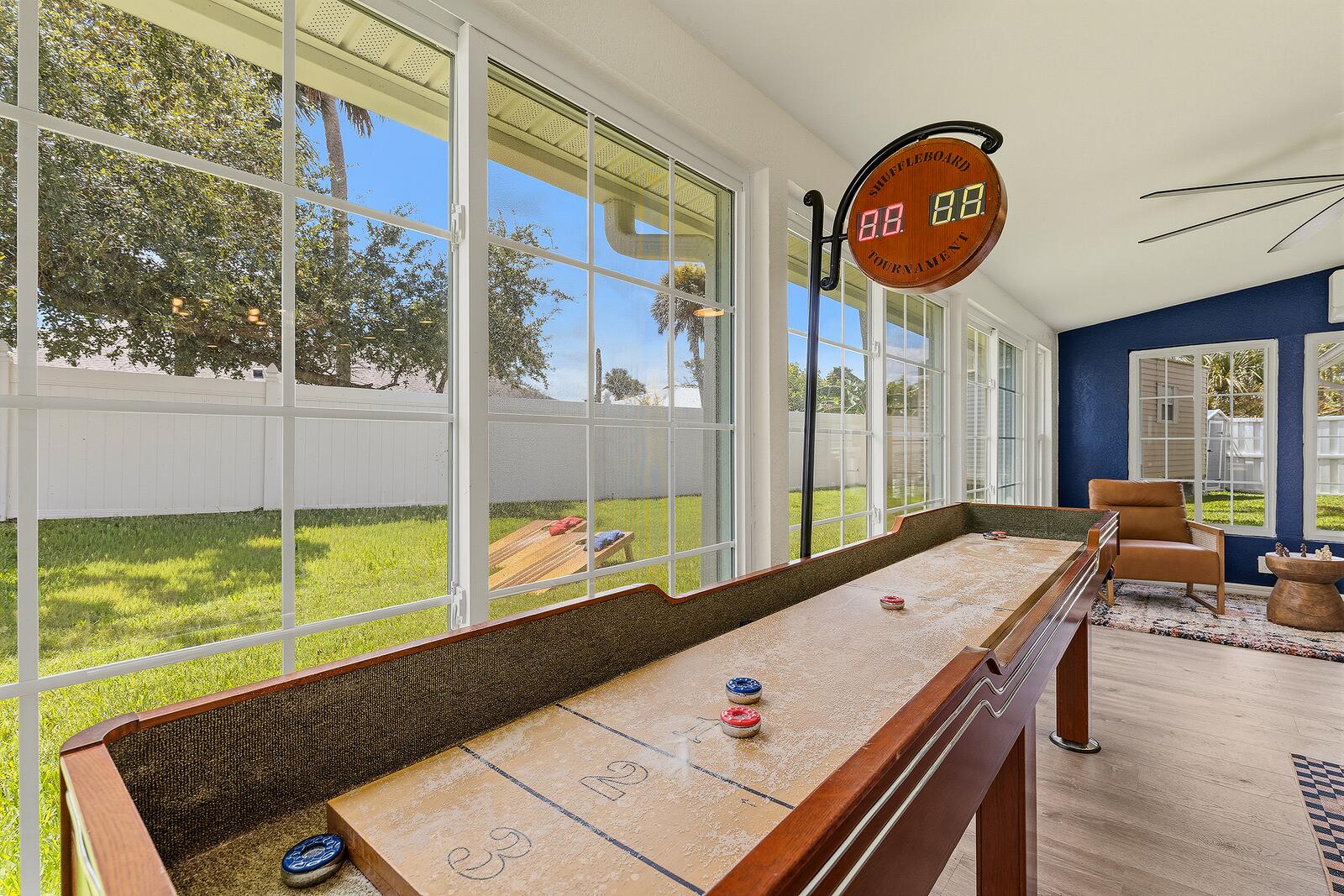 Shuffleboard table with digital scoreboard in the sunroom